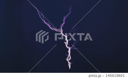 Tesla coil generating high voltage electricity showing a vibrant purple spark discharge Tesla coil generating high voltage electricity showing a vibrant purple spark discharge 140818601