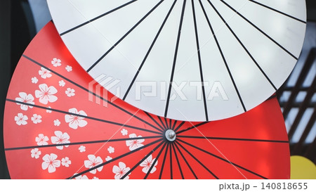 Japanese wagasa umbrella displaying traditional design with cherry blossoms and abstract lines Japanese wagasa umbrella displaying traditional design with cherry blossoms and abstract lines 140818655