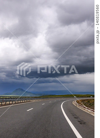 Storm approaching over empty road Storm approaching over empty road 140819560