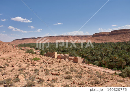A panoramic view of the Aoufous palm grove showcases the lush oasis nestled among the mountains of Morocco. A panoramic view of the Aoufous palm grove showcases the lush oasis nestled among the mountains of Morocco. 140820776