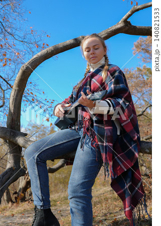 Blonde woman playing guitar ukulele outdoors in autumn forest. Concept of sound therapy, mental health and wellness rituals. Calmness tranquility audio-sensory practices. Aura farming Blonde woman playing guitar ukulele outdoors in autumn forest. Concept of sound therapy, mental health and wellness rituals. Calmness tranquility audio-sensory practices. Aura farming 140821533