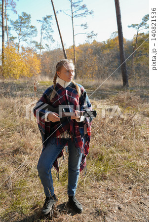 Blonde woman playing guitar ukulele outdoors in autumn forest. Concept of sound therapy, mental health and wellness rituals. Calmness tranquility audio-sensory practices. Aura farming Blonde woman playing guitar ukulele outdoors in autumn forest. Concept of sound therapy, mental health and wellness rituals. Calmness tranquility audio-sensory practices. Aura farming 140821536