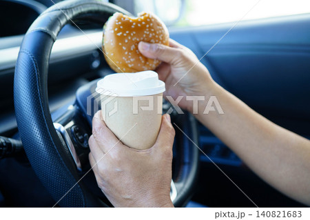 Asian woman driver hold coffee cup for drink in car. Asian woman driver hold coffee cup for drink in car. 140821683
