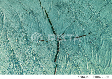 Closeup of green painted tree stump showing natural wood grain cracks weathered texture creating rustic abstract background for design decorative projects Closeup of green painted tree stump showing natural wood grain cracks weathered texture creating rustic abstract background for design decorative projects 140822086