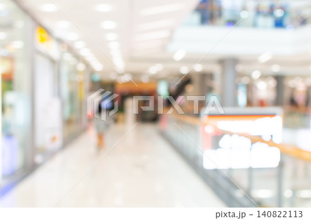 Soft focus shopping mall interior modern retail corridor bright lighting empty walkway defocused background ideal for commercial business advertising copy space Soft focus shopping mall interior modern retail corridor bright lighting empty walkway defocused background ideal for commercial business advertising copy space 140822113