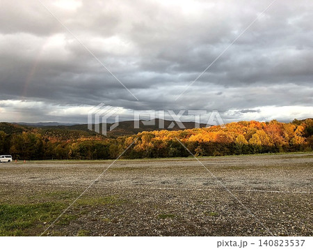 夕陽に照らされた紅葉の山並みと劇的な秋空の風景 夕陽に照らされた紅葉の山並みと劇的な秋空の風景 140823537