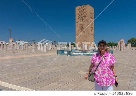A senior traveler smiles during her visit to the large esplanade of the Hassan Tower in Rabat, Morocco. A senior traveler smiles during her visit to the large esplanade of the Hassan Tower in Rabat, Morocco. 140823650