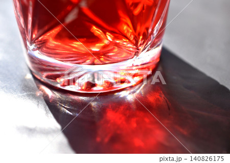A drink with a rich red color in a crystal glass. A drink with a rich red color in a crystal glass. 140826175