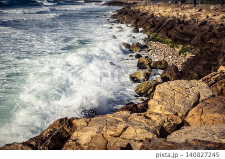 Waves crashing against the rocky coastline with a view of the Mediterranean Sea in Tel Aviv Waves crashing against the rocky coastline with a view of the Mediterranean Sea in Tel Aviv 140827245