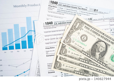 Tax form 1040 U.S. Individual Income Tax Return with dollar banknotes money. Tax form 1040 U.S. Individual Income Tax Return with dollar banknotes money. 140827944
