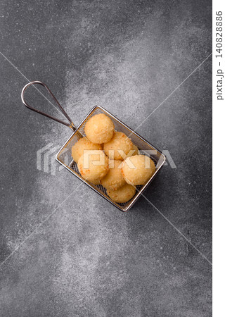 Cheese balls or potato croquettes, golden brown, fried with salt and spices. Cheese balls 140828886