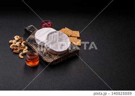 Brie or Camembert cheese is a white, round shape for baking and melting. Camembert cheese Brie or Camembert cheese is a white, round shape for baking and melting. Camembert cheese 140828889