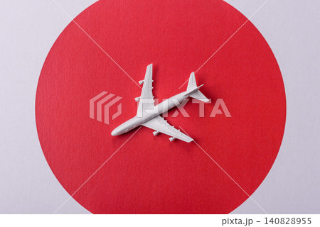 An airplane on the japanese flag as a conceptual backdrop. An airplane on the japanese flag An airplane on the japanese flag as a conceptual backdrop. An airplane on the japanese flag 140828955