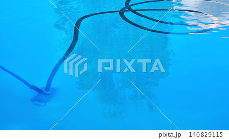 Cleaning of pool. Mopping the bottom under blue water Cleaning of pool. Mopping the bottom under blue water 140829115