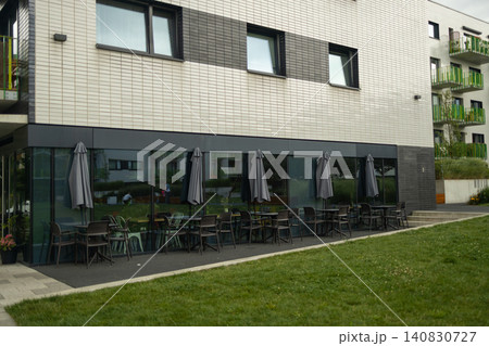 Modern apartment building facade with outdoor cafe on ground floor Modern apartment building facade with outdoor cafe on ground floor 140830727