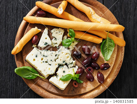 Premium blue cheese board with grissini and olives Premium blue cheese board with grissini and olives 140831585