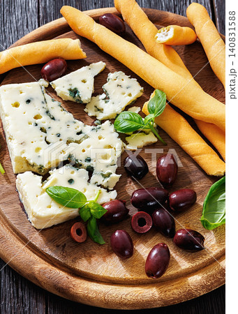 Premium blue cheese board with grissini and olives Premium blue cheese board with grissini and olives 140831588