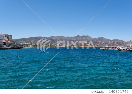 Panoramic view of the sea bay and mountains under clear blue sky in Agios Nikolaos, Crete, Greece Panoramic view of the sea bay and mountains under clear blue sky in Agios Nikolaos, Crete, Greece 140831742
