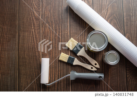 Brushes, wallpaper roll and metal can with paint for repair in a house or apartment on the wood background. Tools for renovation. Brushes, wallpaper roll and metal can with paint for repair in a house or apartment on the wood background. Tools for renovation. 140831748