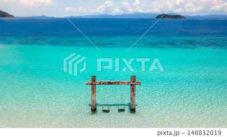 Empty twin wooden swing on Madam beach of Nyaung Oo Phee Island in Myanmar or Burma Empty twin wooden swing on Madam beach of Nyaung Oo Phee Island in Myanmar or Burma 140832019
