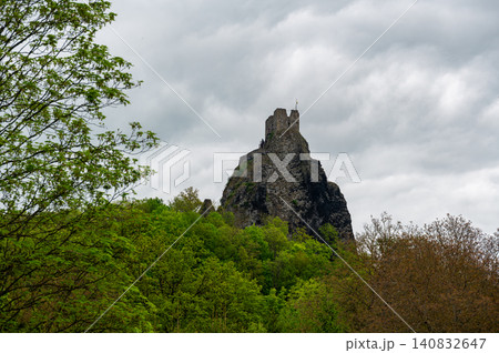 Iconic towers of Trosky Castle Ruins rising on ancient volcanic rock formations beneath dramatic stormy skies in the beautiful Bohemian Paradise, Czech Republic. Iconic towers of Trosky Castle Ruins rising on ancient volcanic rock formations beneath dramatic stormy skies in the beautiful Bohemian Paradise, Czech Republic. 140832647