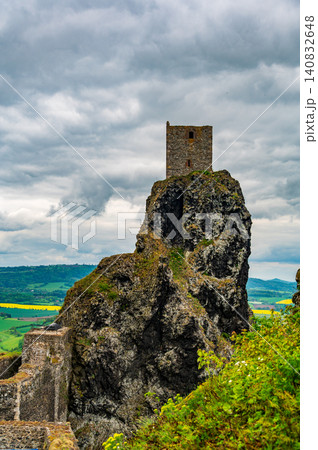 Iconic towers of Trosky Castle Ruins rising on ancient volcanic rock formations beneath dramatic stormy skies in the beautiful Bohemian Paradise, Czech Republic. Iconic towers of Trosky Castle Ruins rising on ancient volcanic rock formations beneath dramatic stormy skies in the beautiful Bohemian Paradise, Czech Republic. 140832648