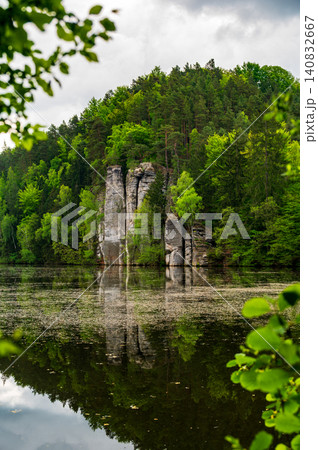 Iconic sandstone cliffs reflected in the calm waters of Vezicky Pond (Vezicky rybnik in czech) in the beautiful Bohemian Paradise, Czech Republic, a famous scenic destination popular with tourists. Iconic sandstone cliffs reflected in the calm waters of Vezicky Pond (Vezicky rybnik in czech) in the beautiful Bohemian Paradise, Czech Republic, a famous scenic destination popular with tourists. 140832667