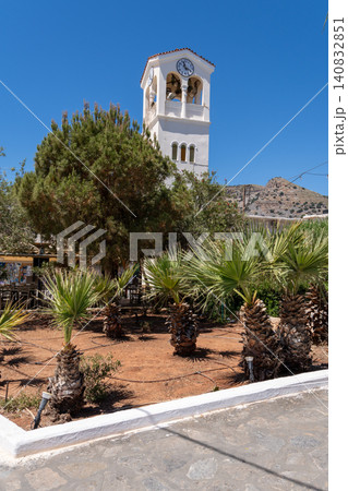 Vertical shot of the white clock tower and belfry of the Orthodox Church of Saints Constantine and Helena in Elounda, Crete, Greece 140832851