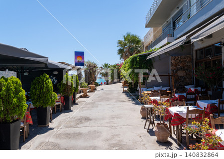 Cozy outdoor restaurant tables and traditional Greek taverns on a coastal street in Elounda, Crete, Greece 140832864