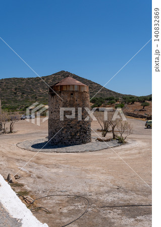 Vertical shot of old historical stone windmill on the Spinalonga peninsula near Elounda, Crete, Greece Vertical shot of old historical stone windmill on the Spinalonga peninsula near Elounda, Crete, Greece 140832869