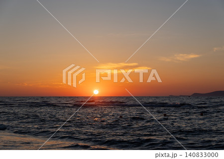 Vibrant orange sunset glow over calm ocean horizon Vibrant orange sunset glow over calm ocean horizon 140833000