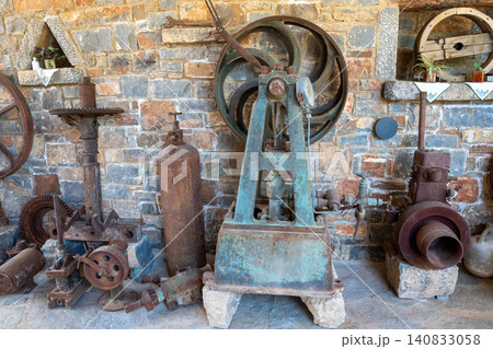 Vintage mechanical pump machine in old olive oil factory museum Vintage mechanical pump machine in old olive oil factory museum 140833058