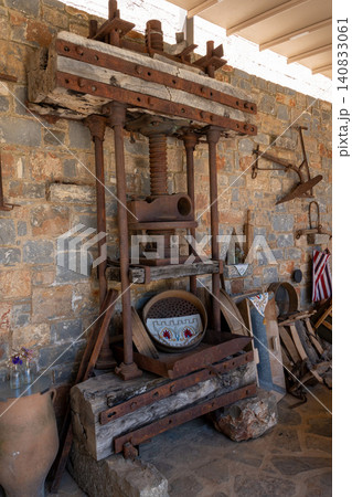 Ancient wooden screw press for traditional olive oil extraction 140833061