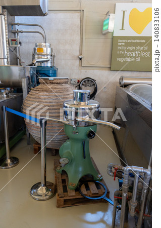 Vintage separator machine and ancient clay amphora in olive oil museum Vintage separator machine and ancient clay amphora in olive oil museum 140833106