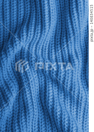 Blue knitted fabric texture with folds, wrinkles and soft waves, crumpled wool background Blue knitted fabric texture with folds, wrinkles and soft waves, crumpled wool background 140834515