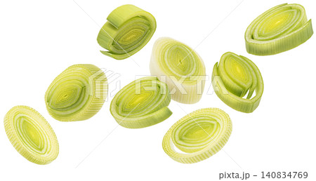 Falling sliced leek isolated on white background, green onion rings, healthy salad ingredient Falling sliced leek isolated on white background, green onion rings, healthy salad ingredient 140834769