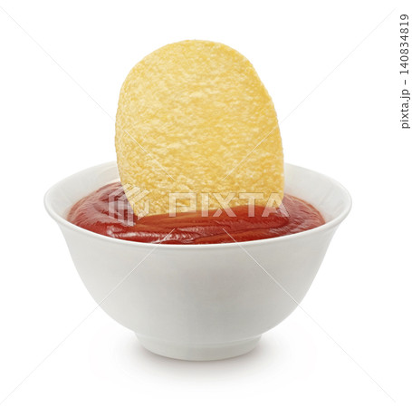Crispy potato chip in ketchup sauce isolated on white background, snack food closeup, fast food concept Crispy potato chip in ketchup sauce isolated on white background, snack food closeup, fast food concept 140834819