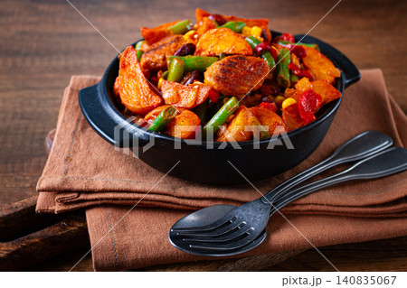 Steakhouse pfanne, fried potato slices, with meatballs, and vegetable mixture, on a black plate, Steakhouse pfanne, fried potato slices, with meatballs, and vegetable mixture, on a black plate, 140835067