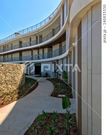Curved modern building facade and pathway oropesa del mar Curved modern building facade and pathway oropesa del mar 140835550