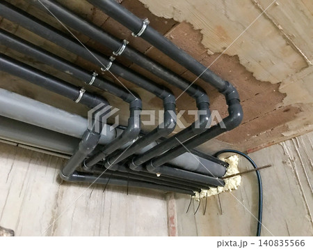 Multiple grey pvc pipes for plumbing installation on ceiling Multiple grey pvc pipes for plumbing installation on ceiling 140835566