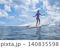Young Surfer Balancing Gracefully Under Ominous Clouds In Ocean 140835598