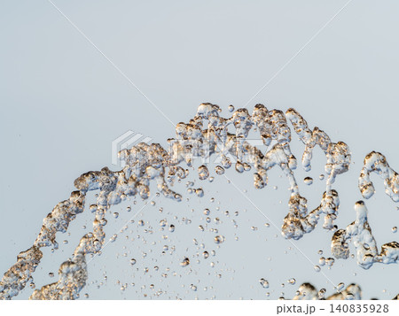 Splashes and jets of water against light background. Splashes and jets of water against light background. 140835928
