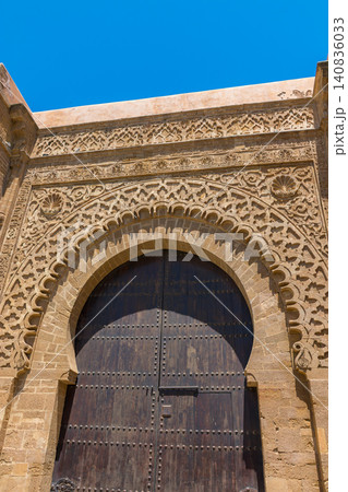 The enormous wooden and stone Bab Udaya gate welcomes visitors to the Kasbah of the Udayas in Morocco 140836033