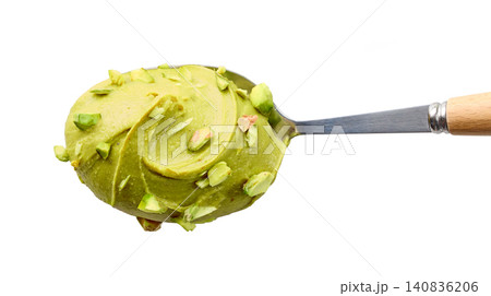 spoon of pistachio spread isolated on white background spoon of pistachio spread isolated on white background 140836206