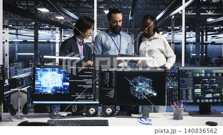 Happy data infrastructure center team members tracking neural network AI large language model visualization. 140836562