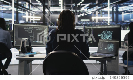 Irritated high tech server room technical specialist punching desk, irked by glitches. Irritated high tech server room technical specialist punching desk, irked by glitches. 140836595
