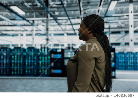 Data center technician uses AI on a tablet to help customers resolve website hosting and uptime problems. 140836687