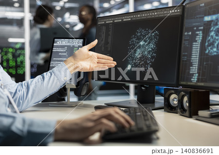 Data center programmer uses a desktop computer in a data center to manage AI virtualization and optimize server infrastructure. 140836691
