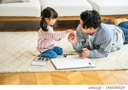 クレヨンでお絵描きをする幼い子供とパパ クレヨンでお絵描きをする幼い子供とパパ 140836929
