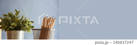 Banner Plant pot sharp pencil vase office supply decor on wood table. Green decorate home office desk. Green plant vase on wood office desk sharpen pencil box office decorate table with copy space 140837247